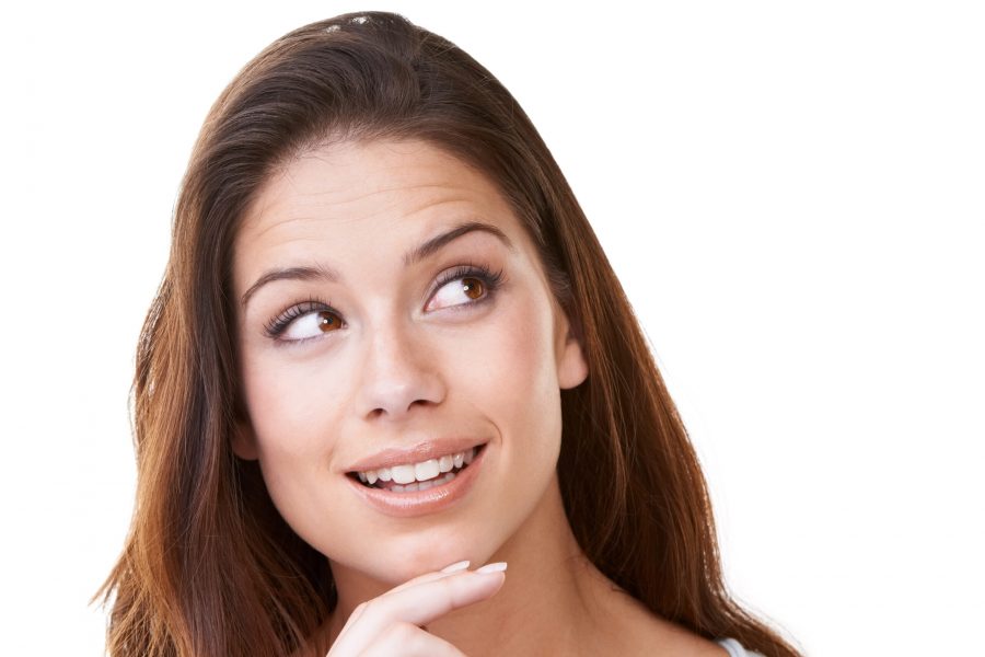 A lovely young brunette looking at something while isolated on white